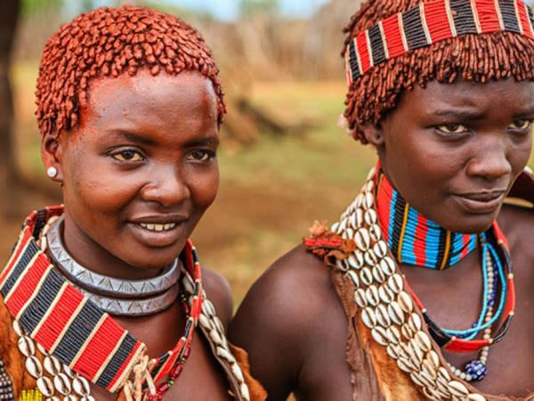 Ethiopian women wearing traditional beadwork, representing cultural respect